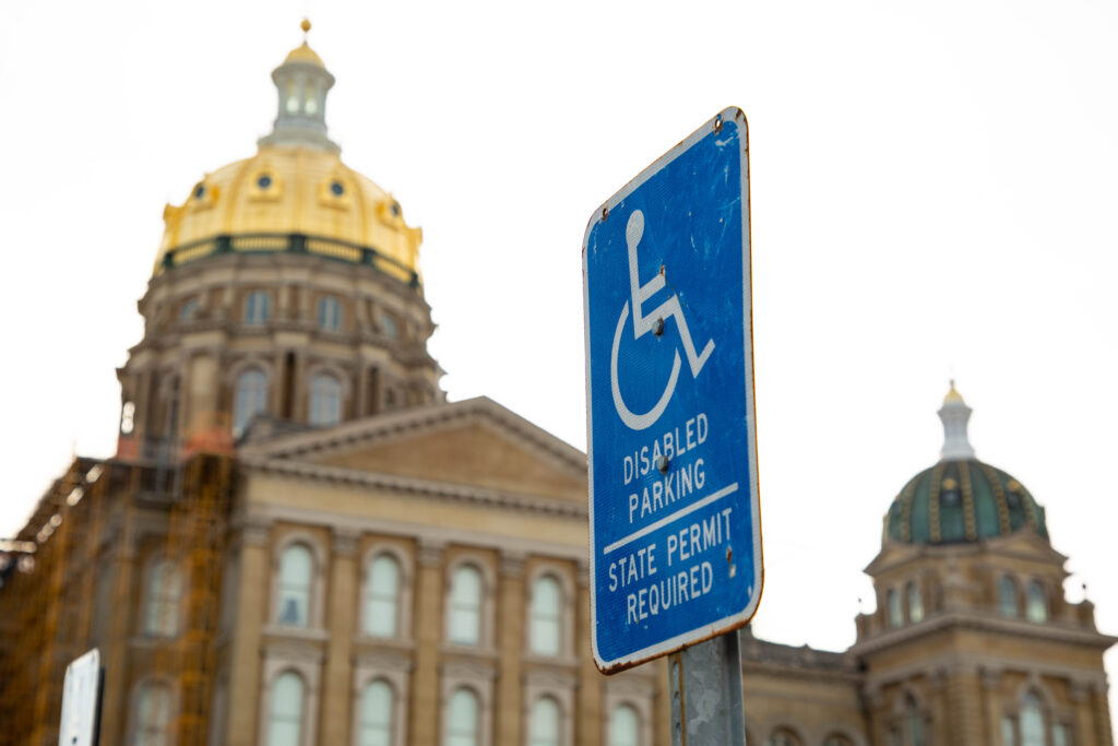 One of many handicap parking signs featuring the official symbol of access that are posted outside the Iowa State Capitol.